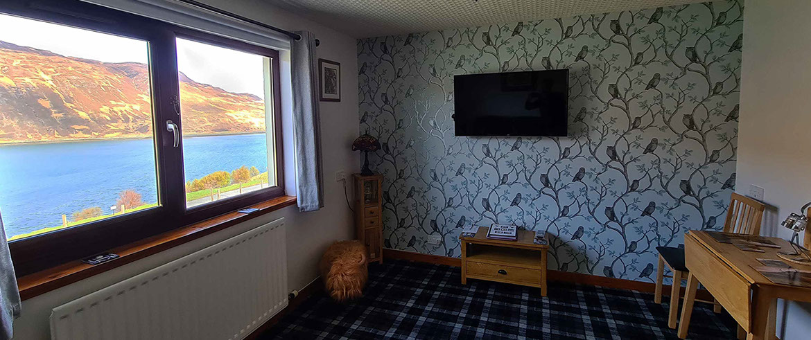 Four poster sea view living room bed and breakfast suite at Loch Aluinn