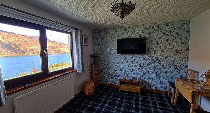 Four poster sea view living room bed and breakfast suite at Loch Aluinn