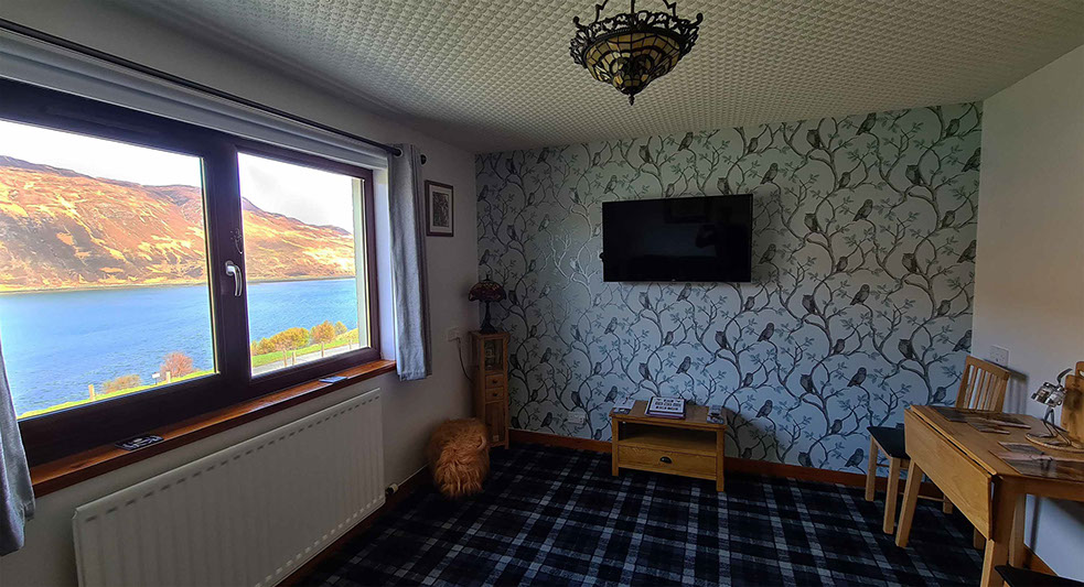 Four poster sea view living room bed and breakfast suite at Loch Aluinn
